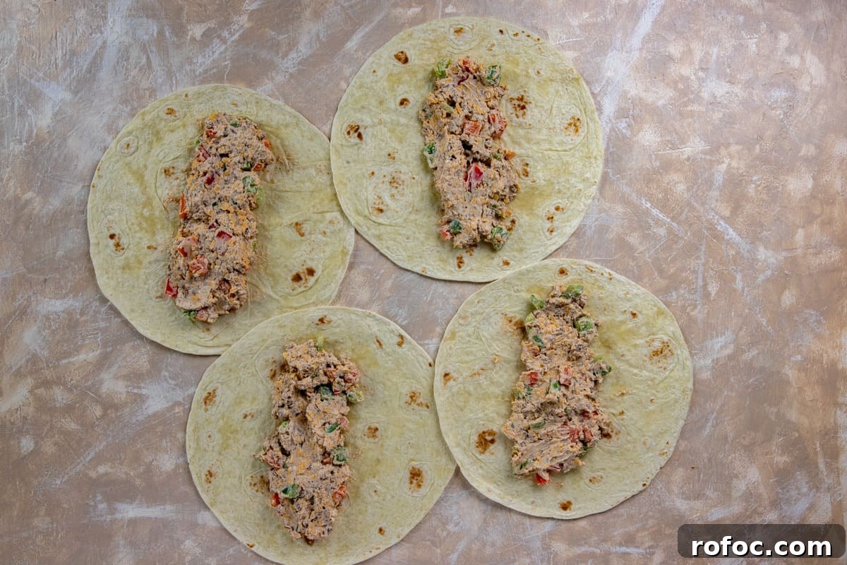 Taco Meat Pinwheels: Quick Party Appetizers from Leftovers 5 Taco meat mixture evenly spread onto four flour tortillas.
