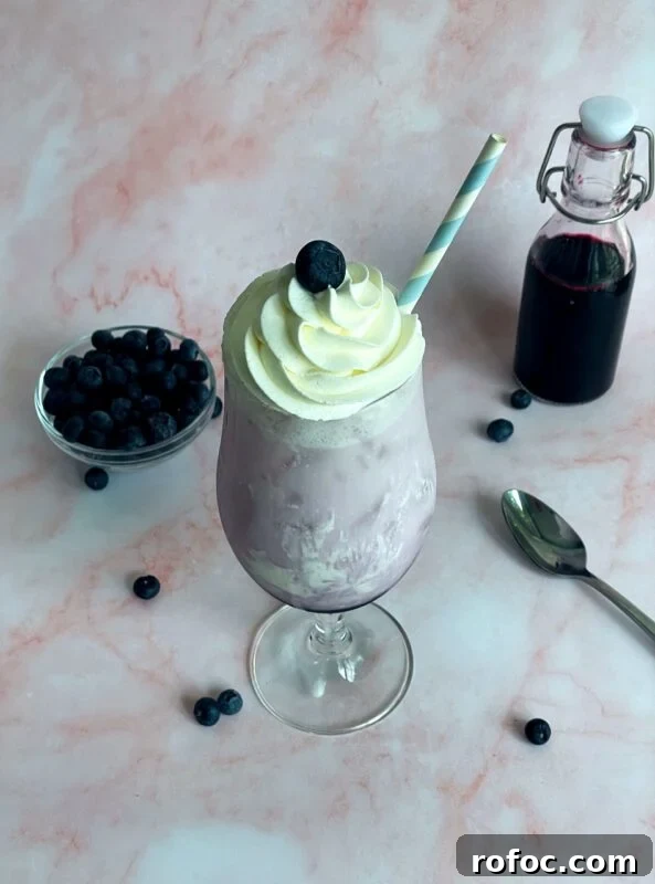 blueberry italian soda with whipped cream on top.