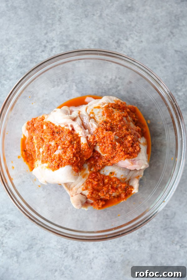 Portuguese Piri-Piri Chicken Thighs with Roasted Potatoes 5 gluten-free chicken covered in peri peri sauce in a bowl