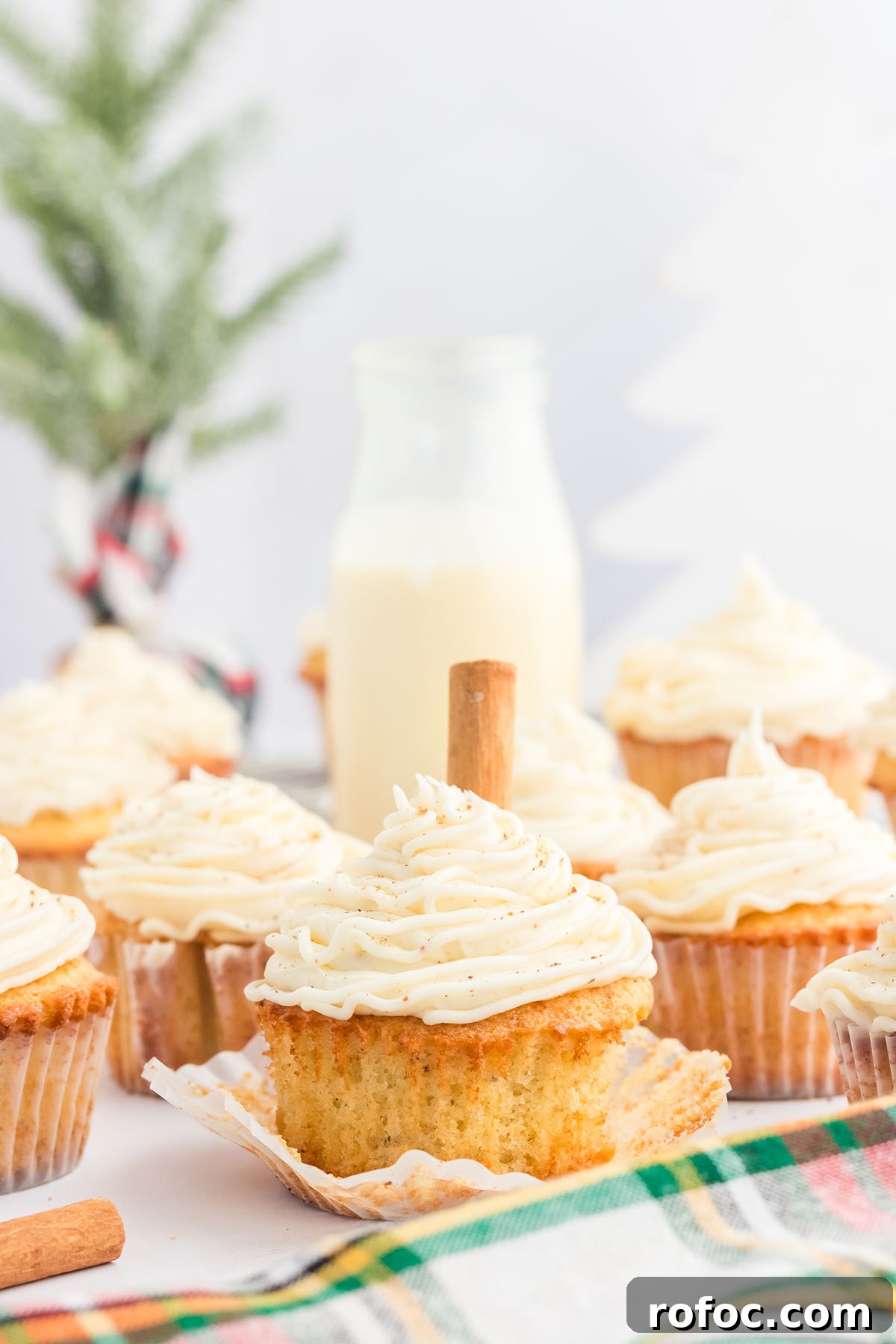 Eggnog Cupcakes with Spiced Rum Buttercream Filling 2 Eggnog cupcakes in cupcake liners topped with eggnog buttercream.