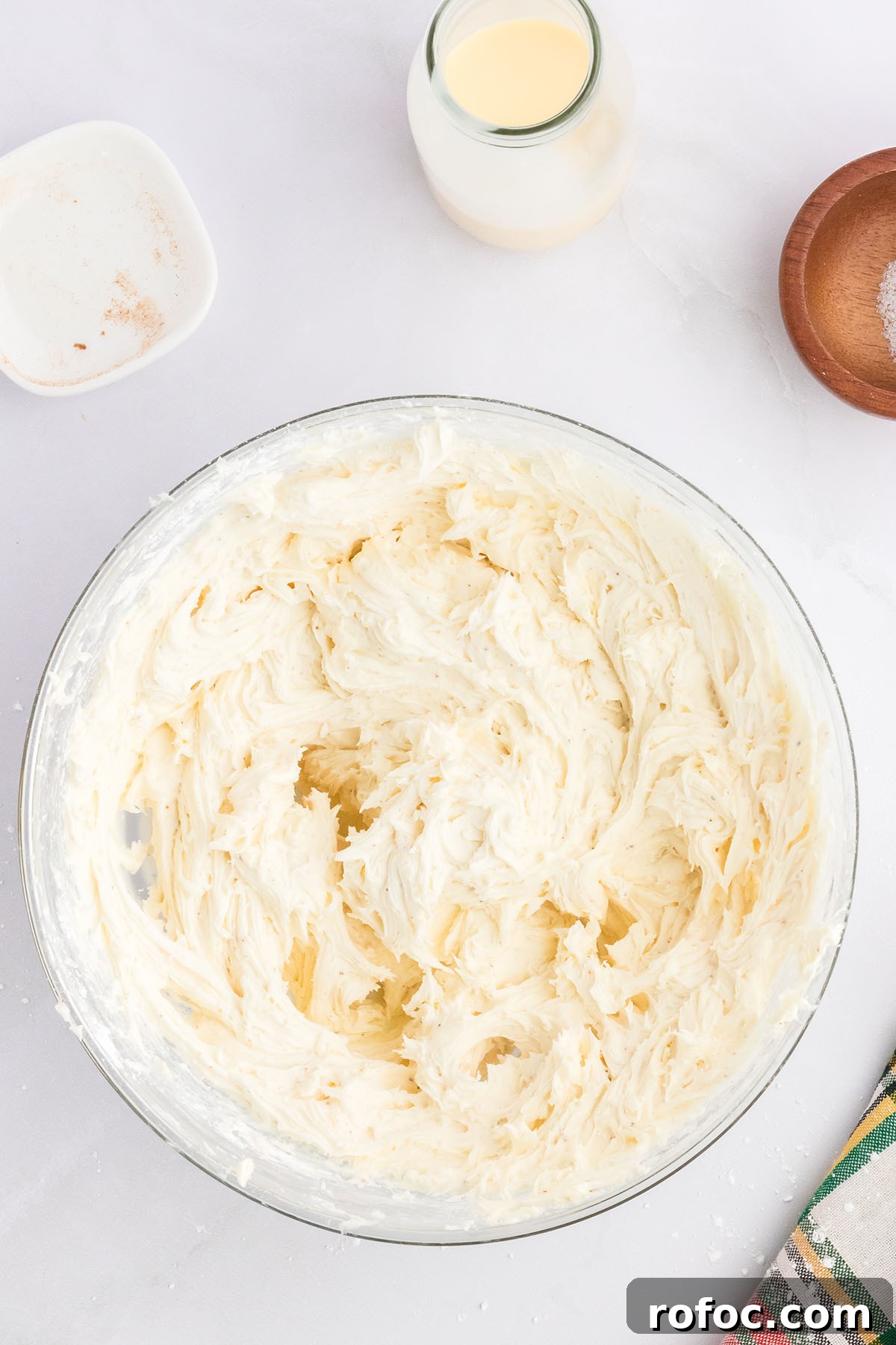Eggnog Cupcakes with Spiced Rum Buttercream Filling 10 Eggnog buttercream frosting in a glass mixing bowl.