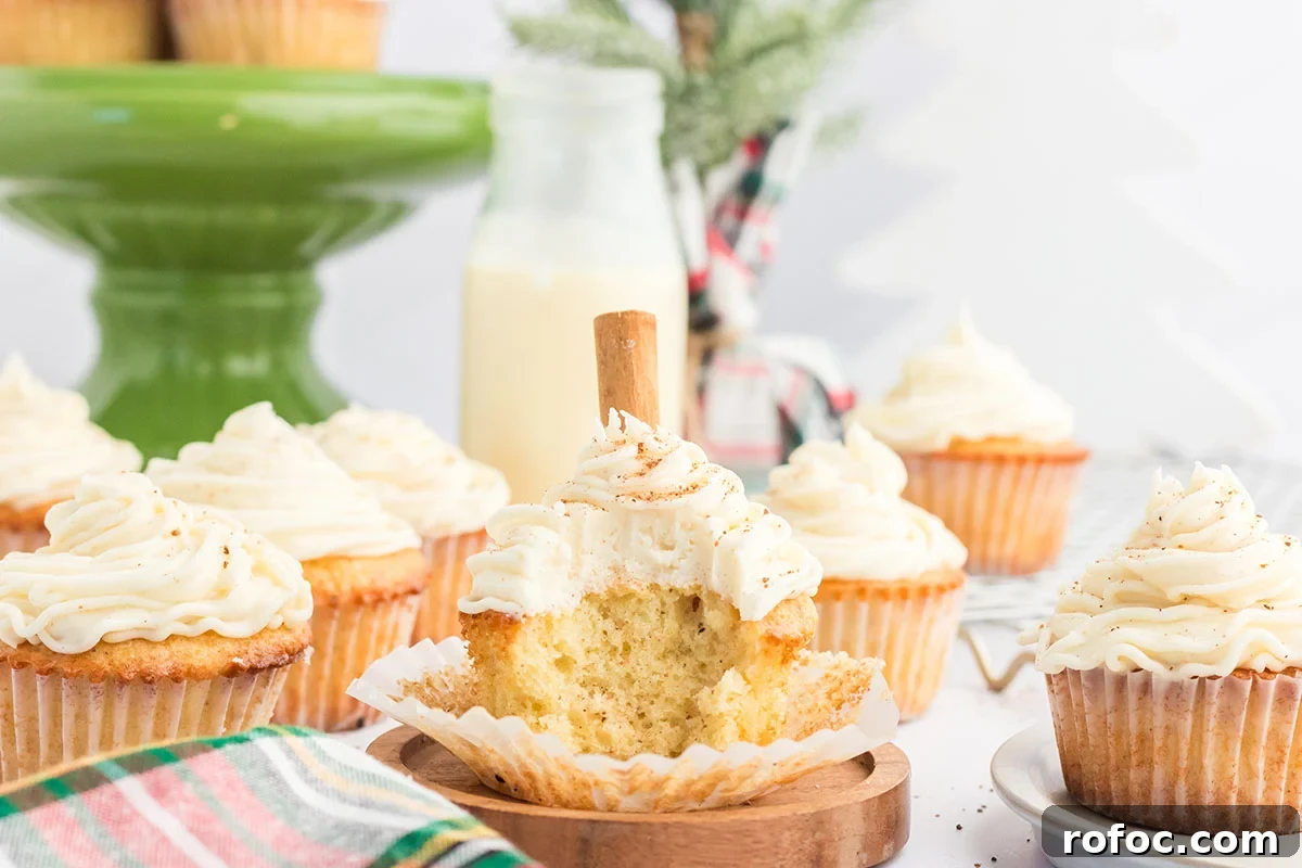Eggnog Cupcakes with Spiced Rum Buttercream Filling 12 Eggnog cupcake with a bite taken out of it.