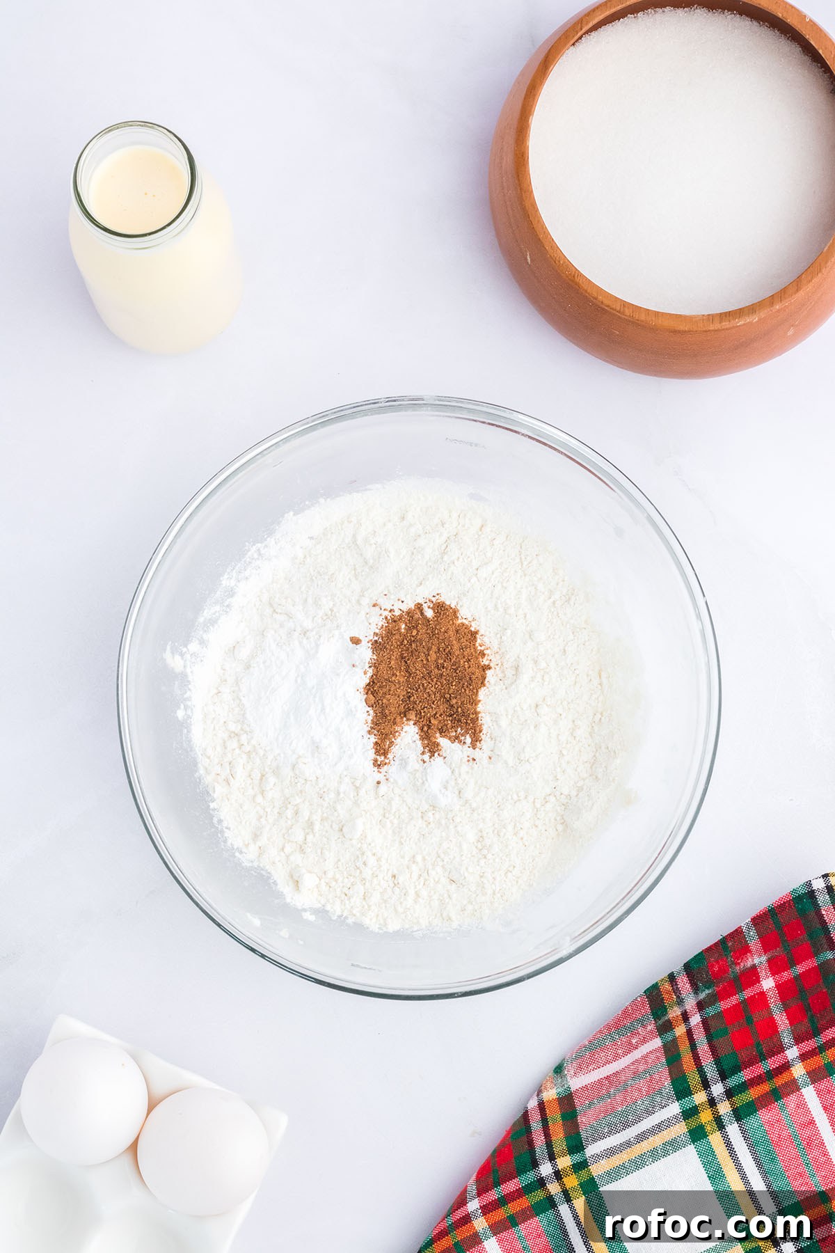 Eggnog Cupcakes with Spiced Rum Buttercream Filling 4 Flour, baking powder, salt, and nutmeg in a glass mixing bowl.