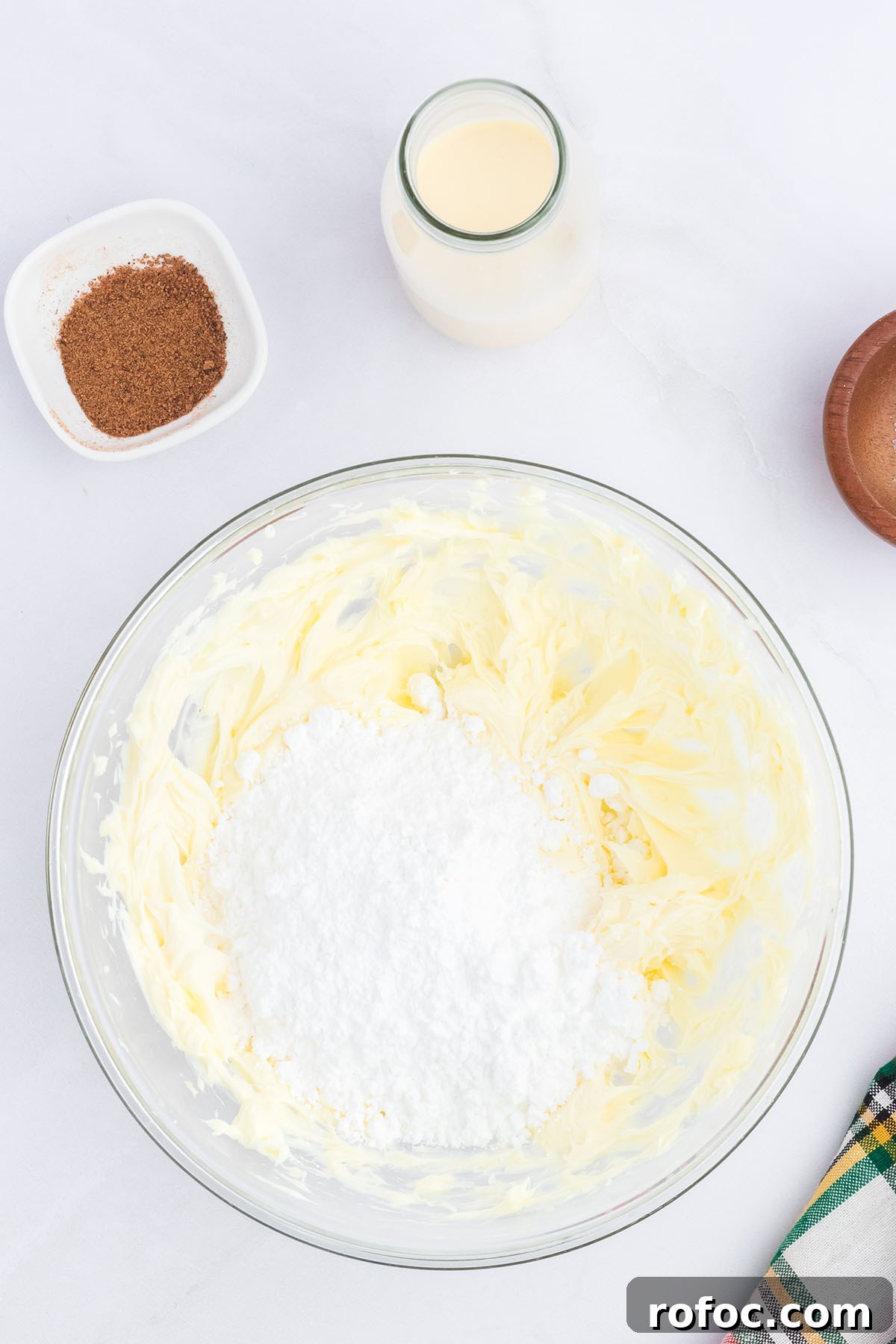 Eggnog Cupcakes with Spiced Rum Buttercream Filling 8 Beaten butter and powdered sugar in a glass mixing bowl.