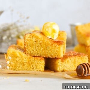 Sourdough Discard Cornbread Recipe: Tangy, Tender & Crispy 13 cornbread stacked on top of each other with butter and honey on top.