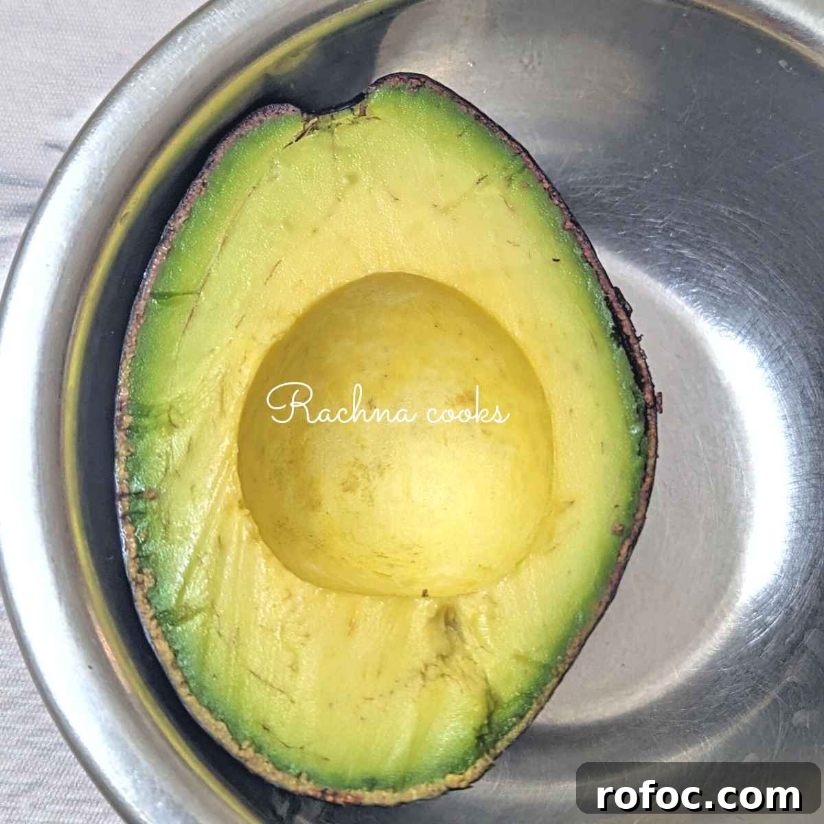 Crispy Air Fryer Avocado Eggs: Quick Breakfast Recipe 4 Half of an avocado after removing the pit.