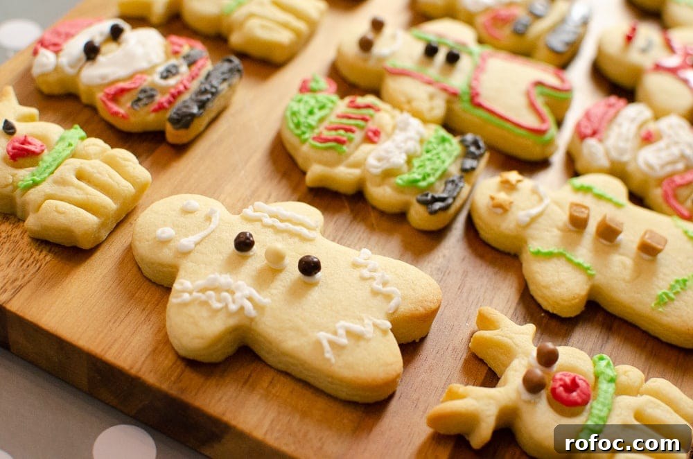Iced Christmas Cookies: How to Cut Shapes and Decorate Sugar Cookies 2 Iced Christmas Biscuits On a wooden chopping board