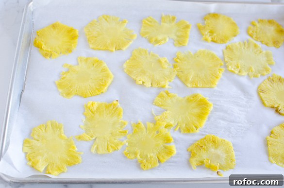 Crispy Dried Pineapple Flowers: Step-by-Step Guide 6 pineapple slices on baking sheet