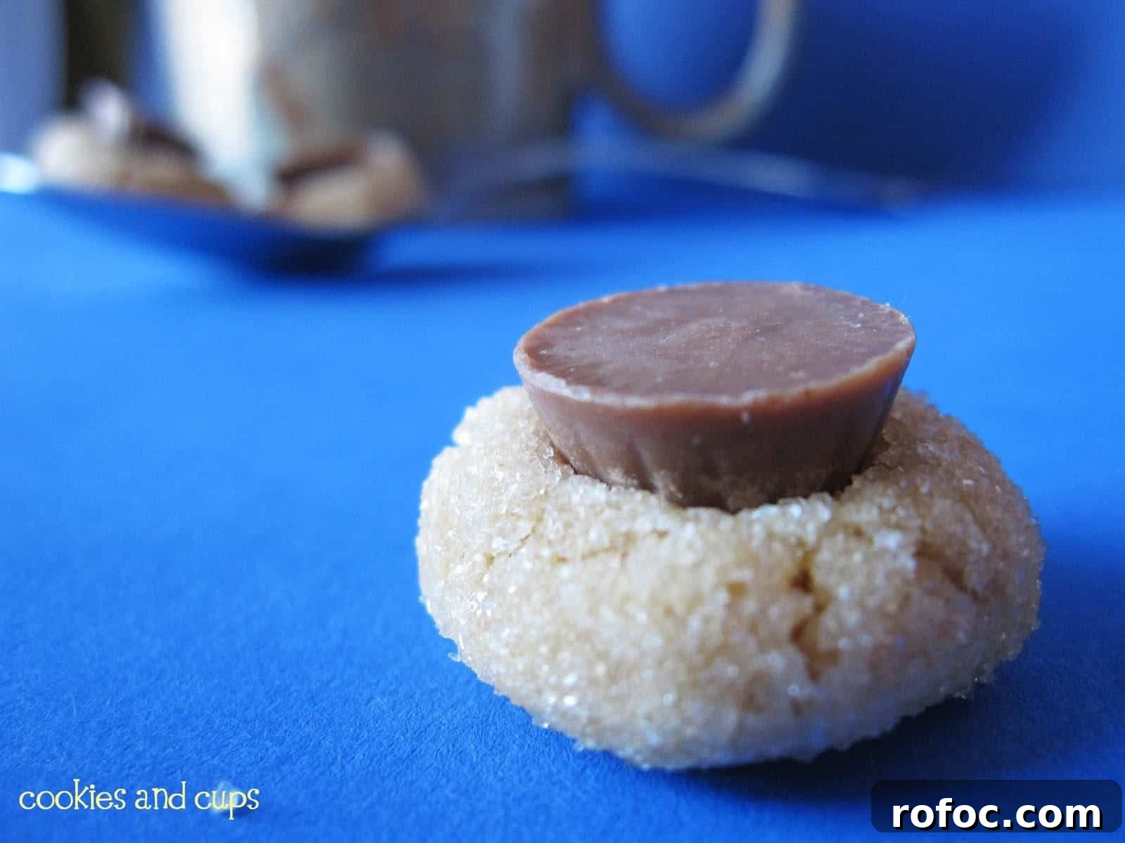 Close-up of a Peanut Butter Blossom cookie with a mini PB cup on top