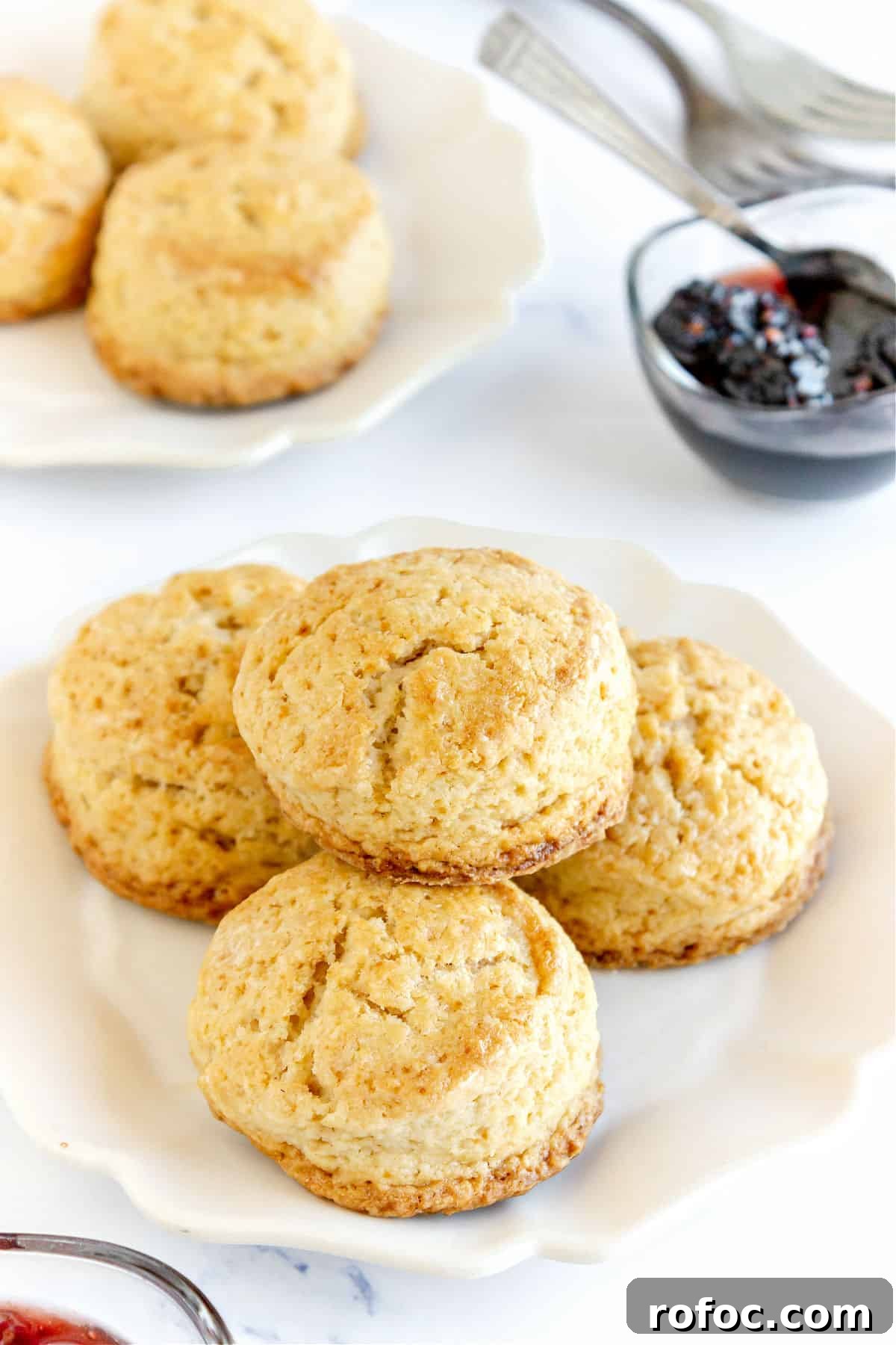 Mini Cream Scones Recipe — Simple Homemade Bite-Sized Scones 3 White plates with scones, white background, bowl with jam.