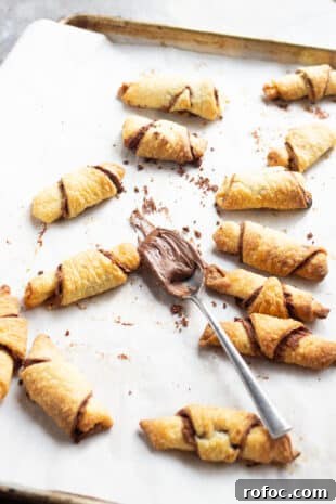 Decadent Nutella Rugelach Recipe: Flaky Chocolate-Filled Pastries 4 Nutella Rugelach with a fork of nutella