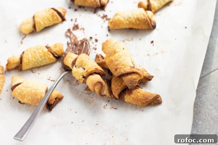 Decadent Nutella Rugelach Recipe: Flaky Chocolate-Filled Pastries 5 Nutella rugelach and a fork of nutella