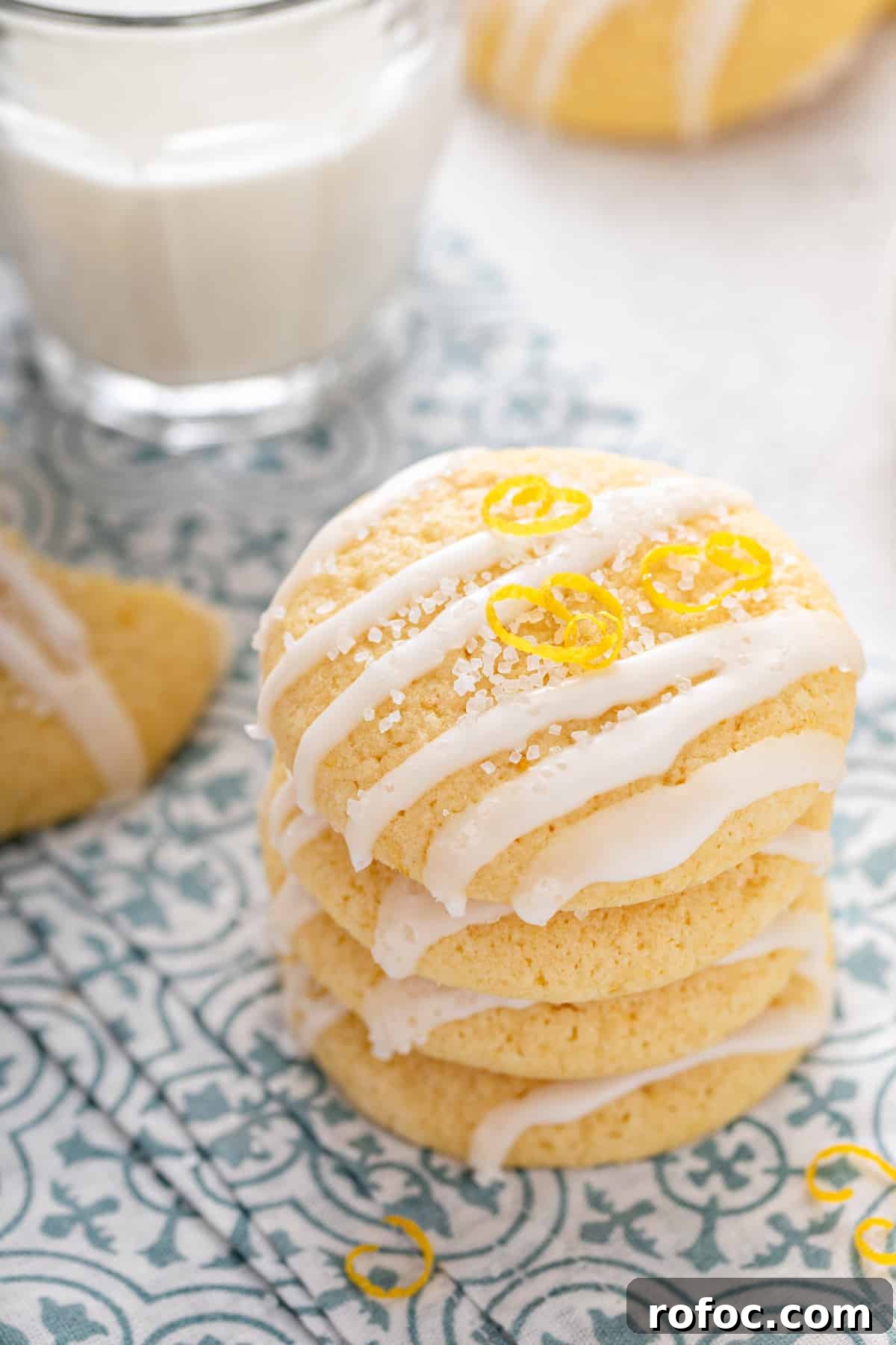 Four pound cake cookies stacked on a blue and white napkin.