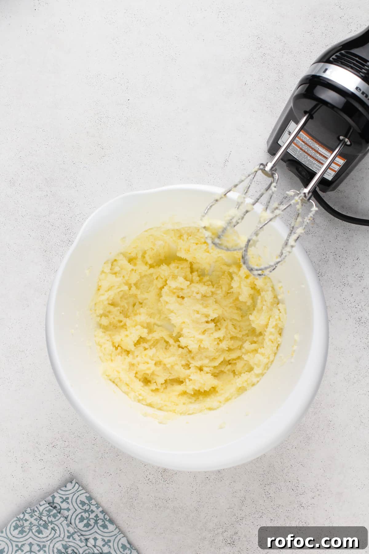 Butter and sugar creamed together in a white bowl.