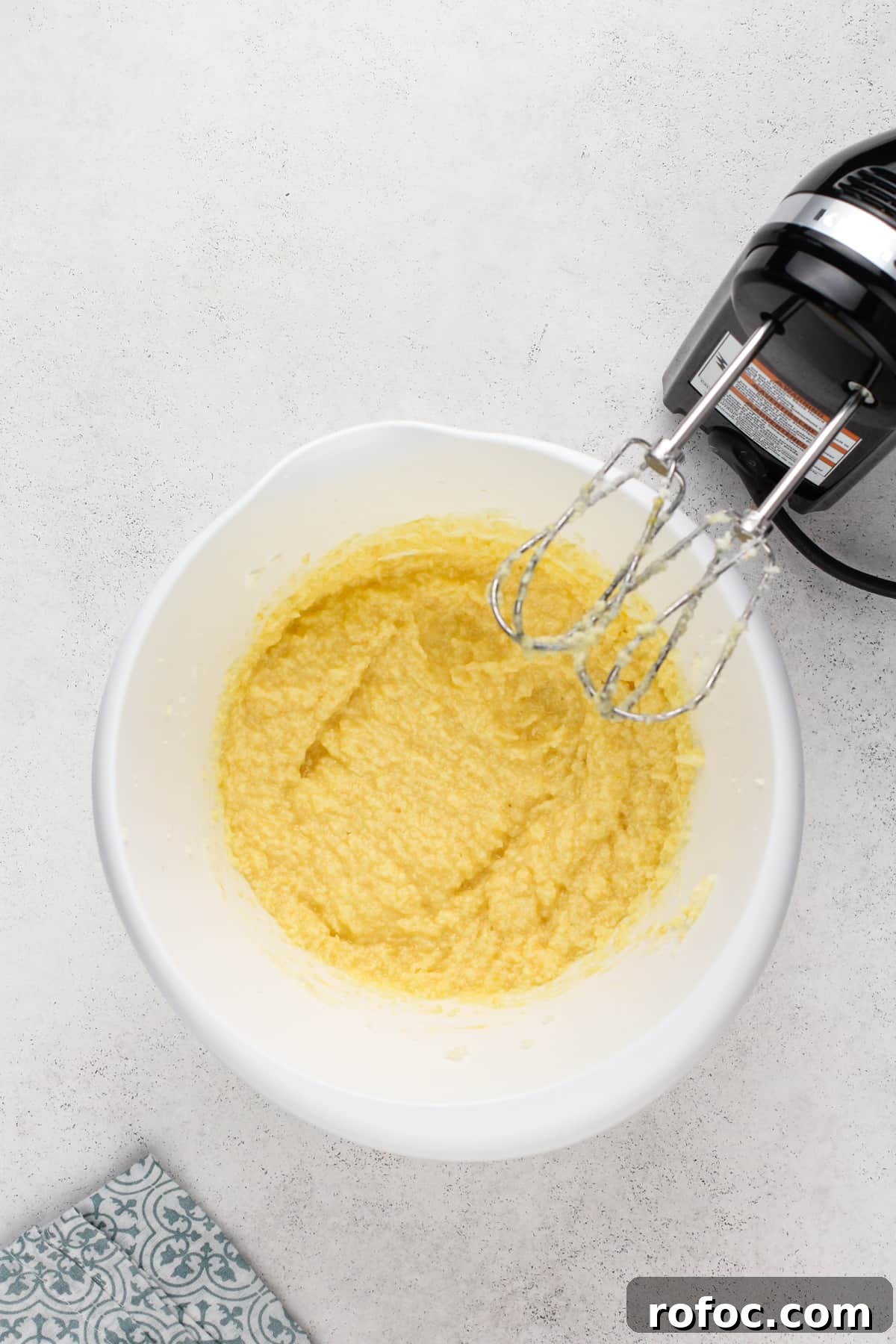Wet ingredients for pound cake cookies mixed in a white mixing bowl.