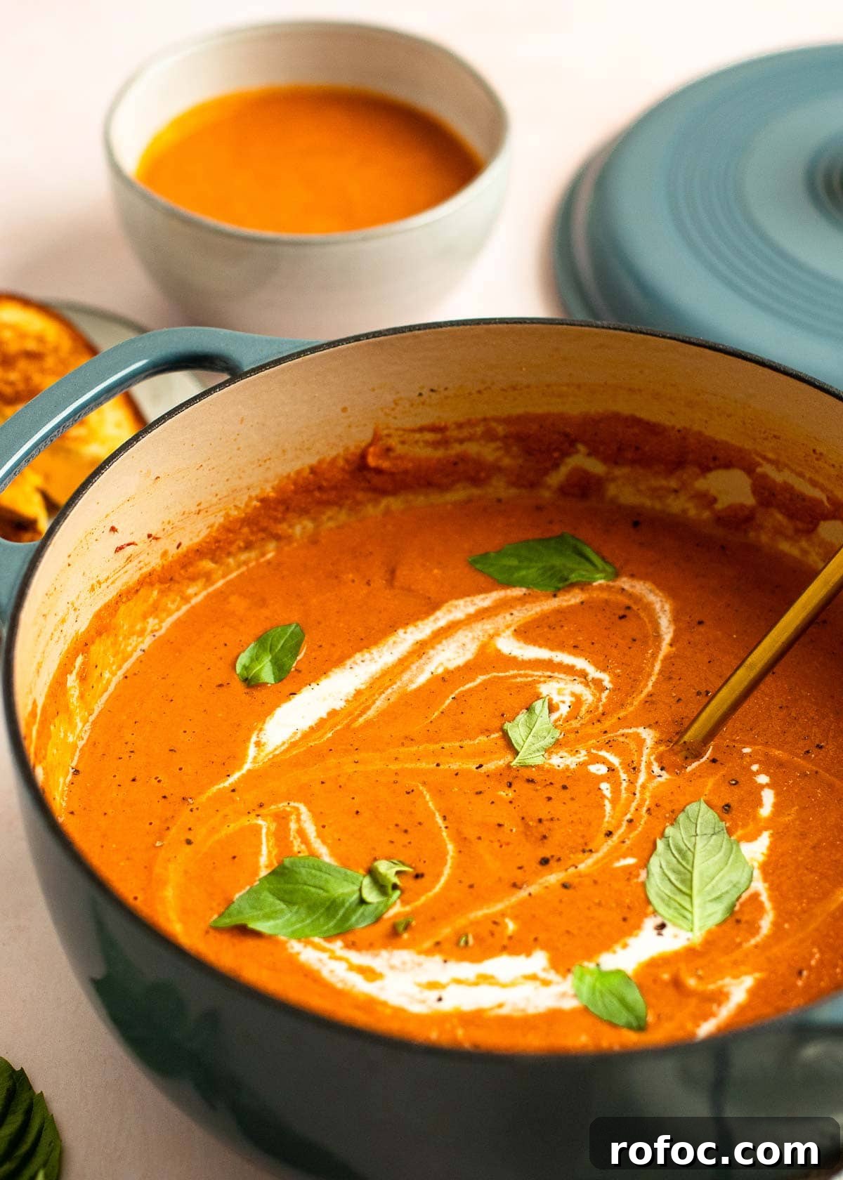 Simple Homemade Tomato Soup Recipe for Rich Flavor 2 dutch oven with tomato soup with a drizzle of heavy cream and basil