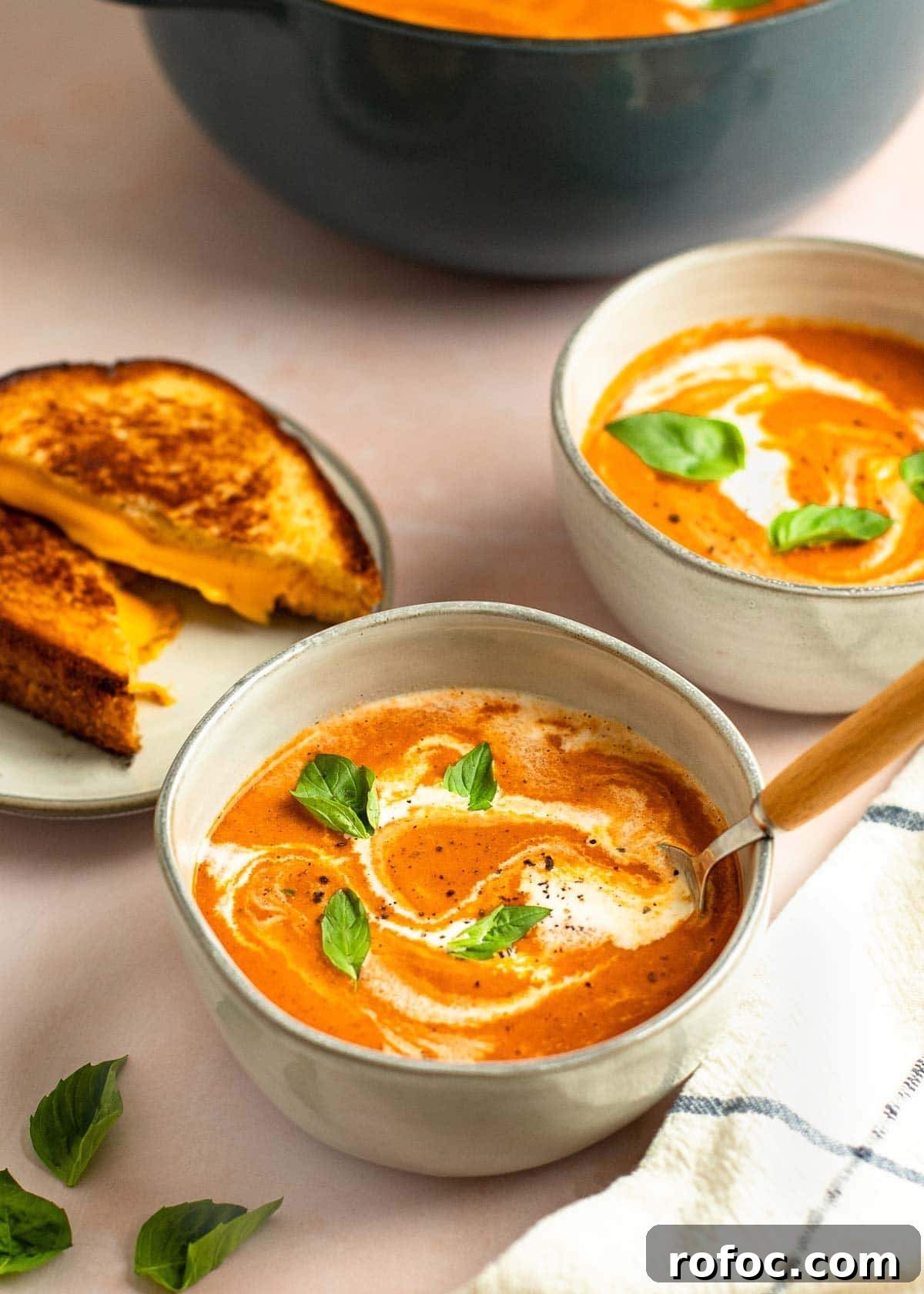 Simple Homemade Tomato Soup Recipe for Rich Flavor 11 tomato soup in bowls with grilled cheese on side