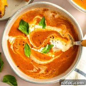 Simple Homemade Tomato Soup Recipe for Rich Flavor 12 tomato soup in a bowl with a drizzle of heavy cream and basil