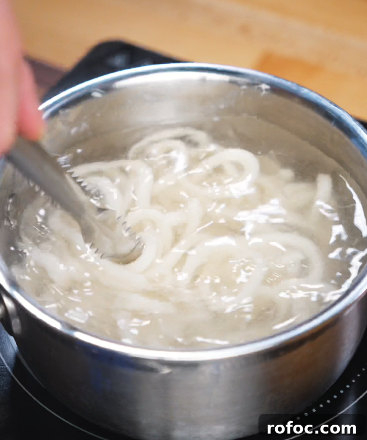 Savory Beef Curry Udon Recipe for Comforting Weeknight Meals 8 Udon noodles boiling in a pot.