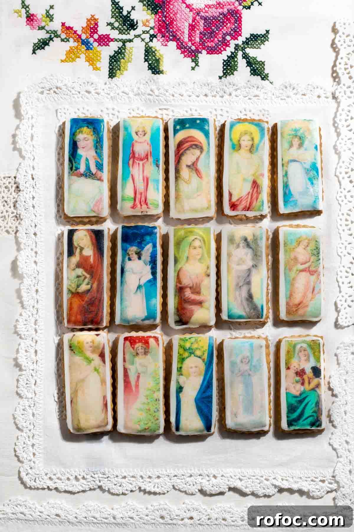 Christmas Cookies Decorated with Edible Wafer Paper (Photo Cookies) 2 Christmas cookies with edible wafer on an embroidered tablecloth.