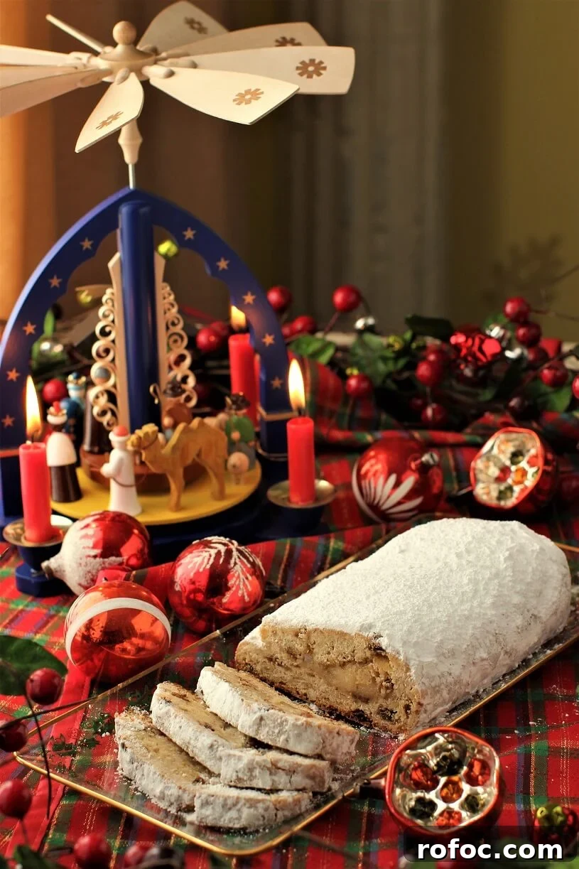 Quarkstollen: A Faster Take on Classic German Christmas Stollen 2 German Christmas Stollen sliced on a plate in front of a Weihnachtspyrimide
