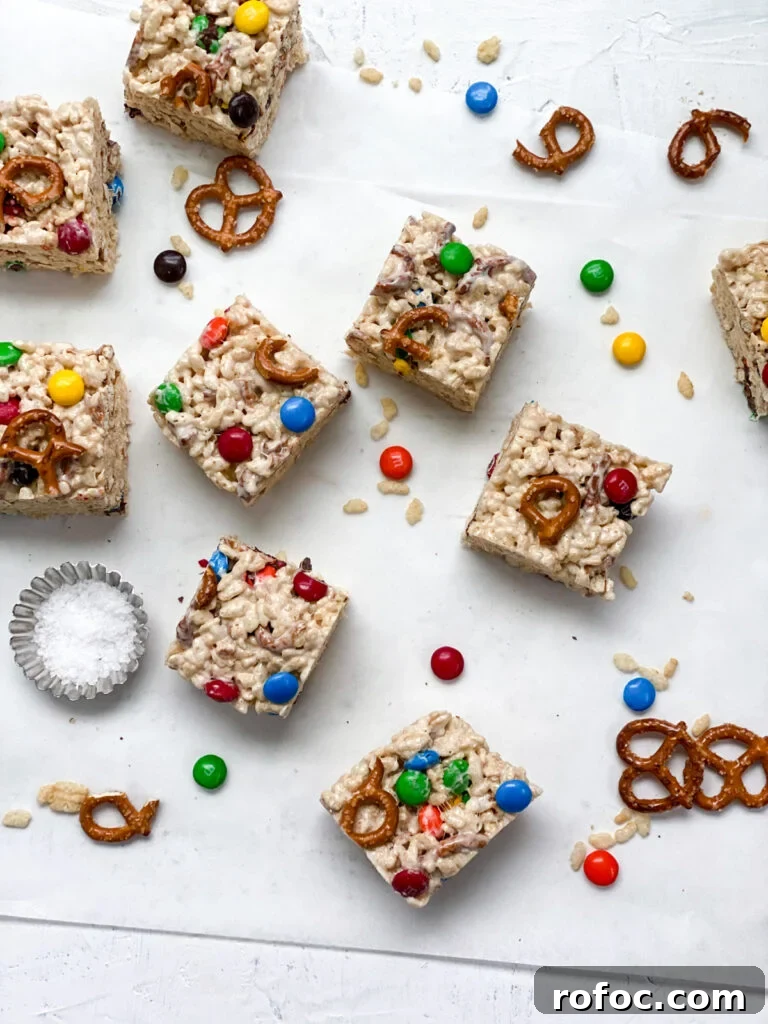 M&M Rice Krispie Treats Recipe: Chewy, Chocolate-Packed Squares 16 cut up M&M rice krispie treats with pretzels and m&m's around them