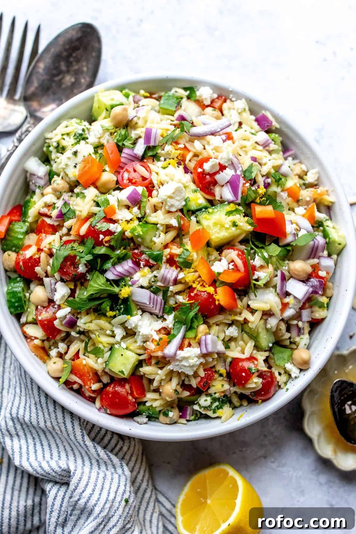 Lemon Honey Orzo with Feta and Fresh Herbs 2 White bowl with close up of Lemon Orzo With feta and almonds.