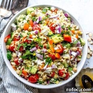 Lemon Honey Orzo with Feta and Fresh Herbs 11 White bowl with close up of Lemon Orzo With feta and almonds.