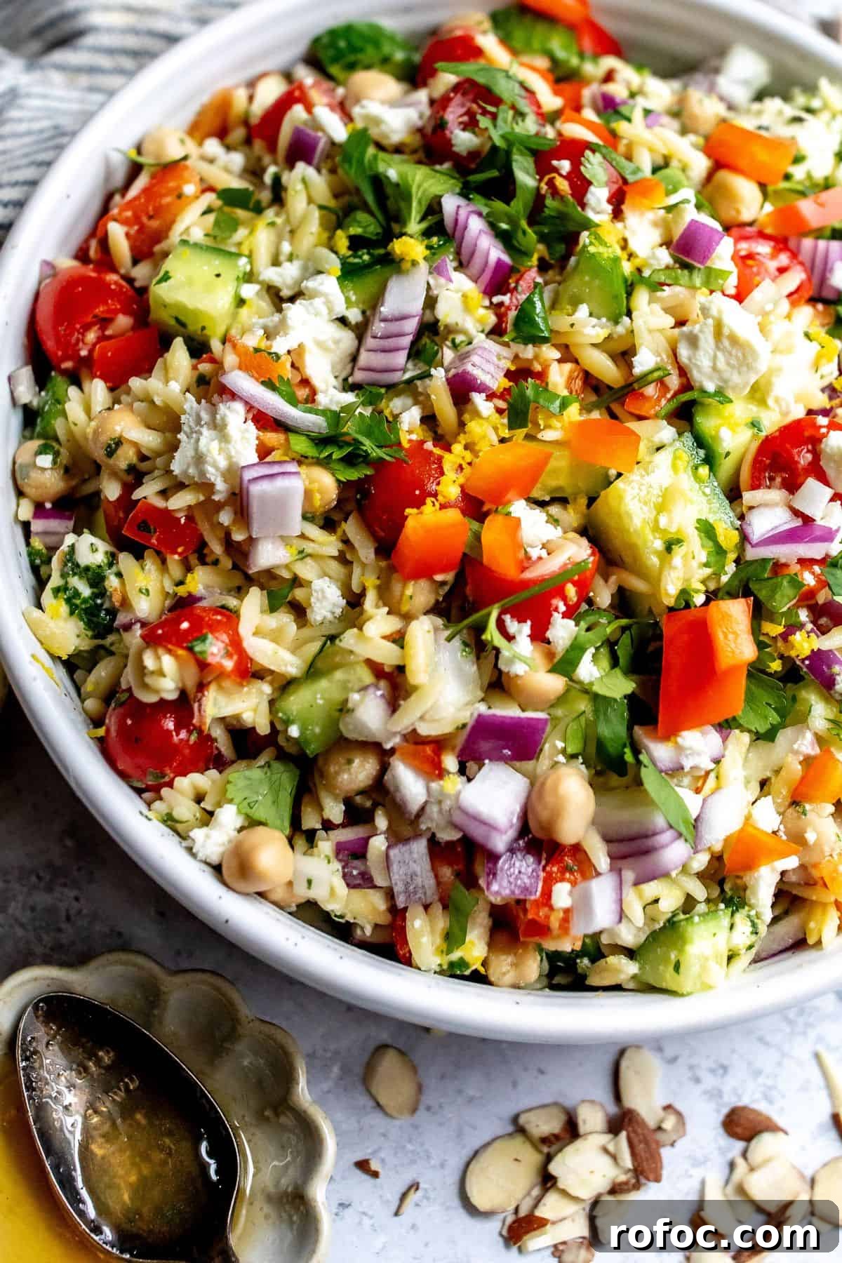Lemon Honey Orzo with Feta and Fresh Herbs 6 White bowl with close up of Lemon Orzo With feta and almonds.