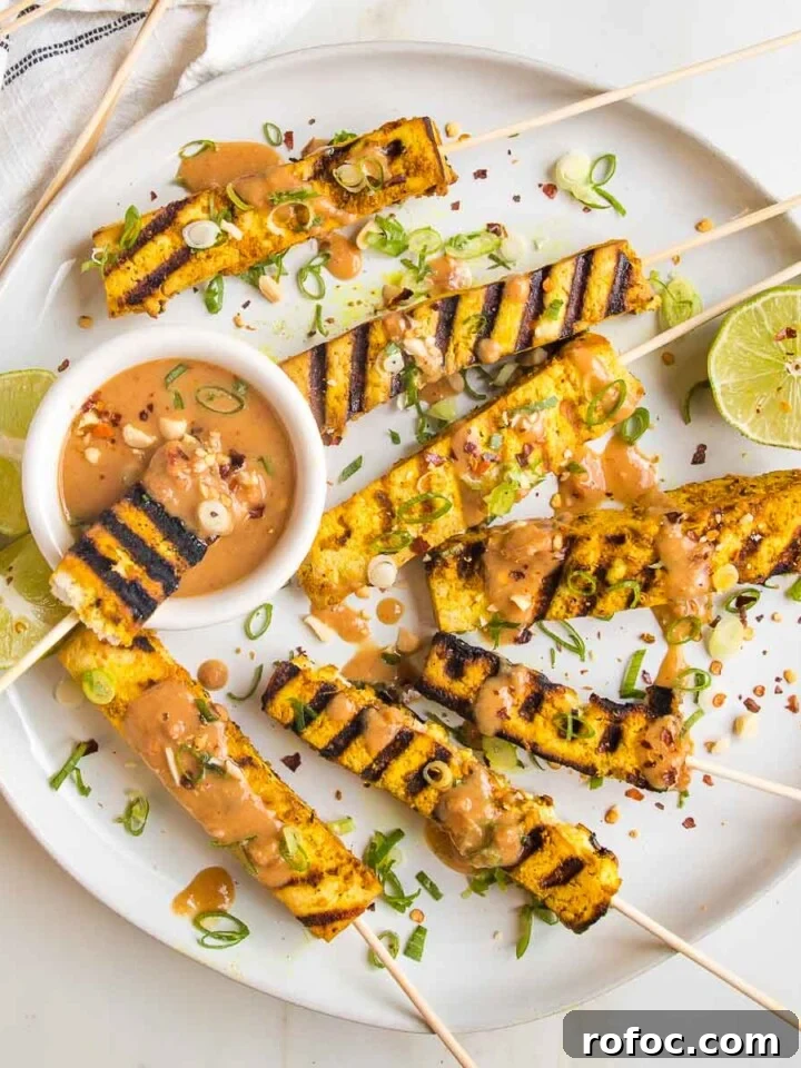Round plate with grilled tofu satay skewers.