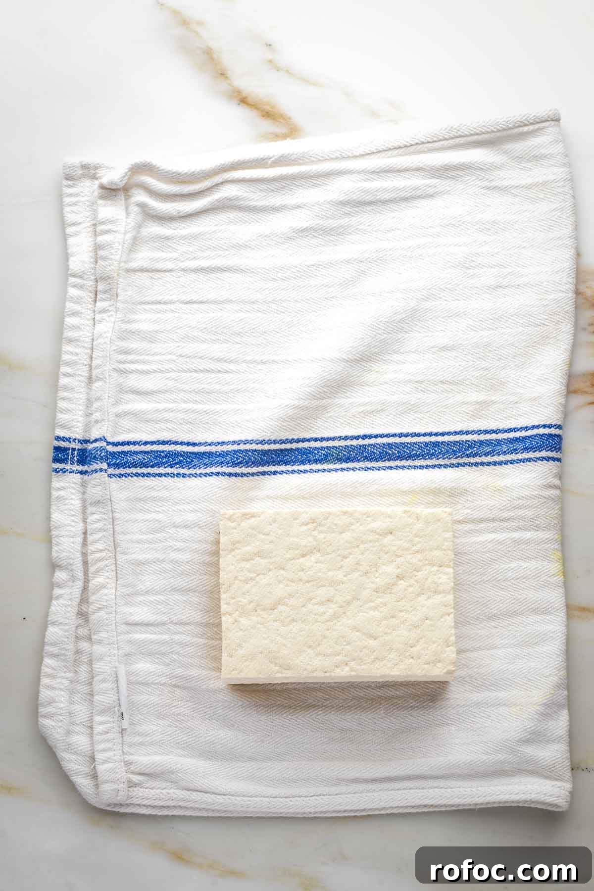 Crispy Orange Tofu — Restaurant-Style Takeout at Home 3 Block of tofu on a kitchen towel.