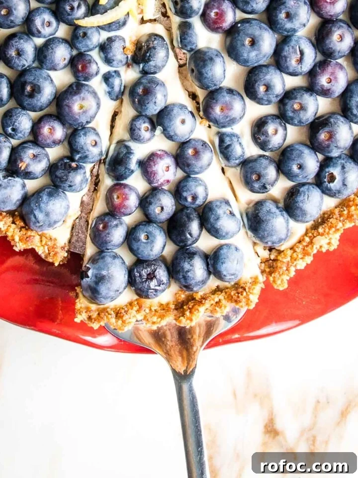 A slice of blueberry tart being served.
