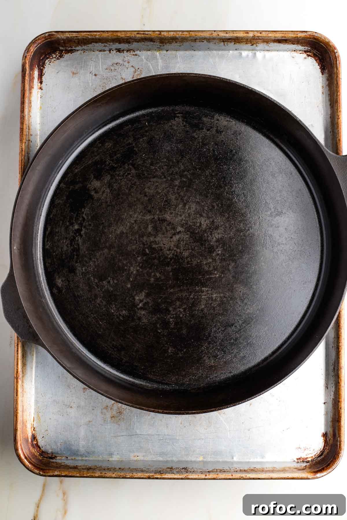 Crispy Orange Tofu — Restaurant-Style Takeout at Home 4 Cast iron skillet on top of a half sheet pan.