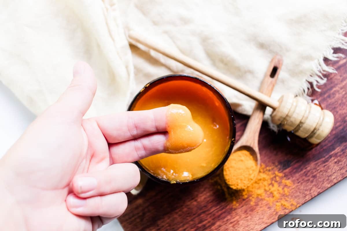 DIY Gel Sea Moss Face Mask Recipe for Glowing Skin 3 Applying sea moss face mask to the face using two fingers.