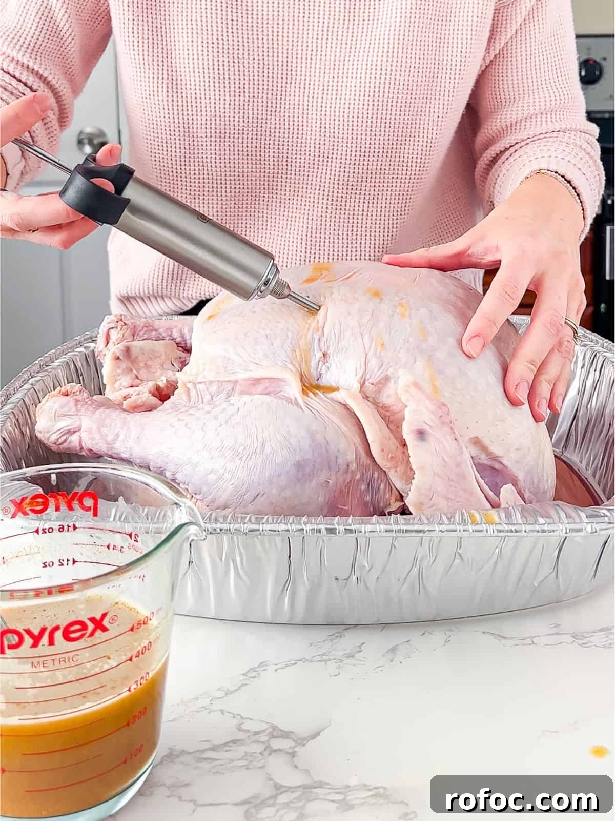Savory Turkey Injection Recipe for Juicy, Flavorful Roasts 2 Injecting the turkey with juice.