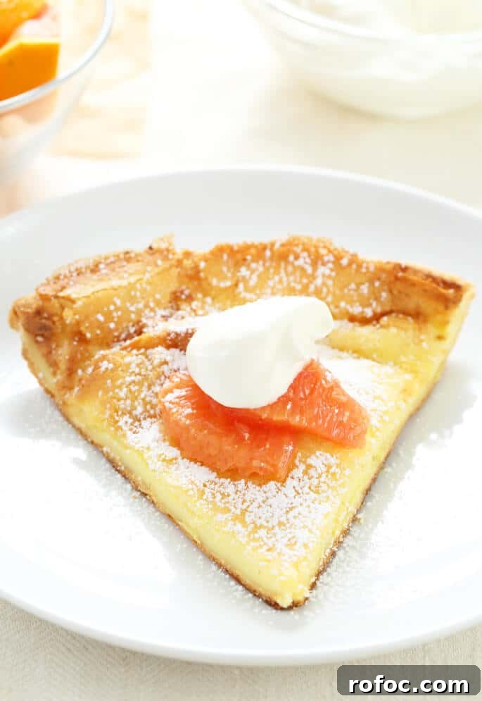 Gluten-Free Dutch Baby Pancake Recipe for Fluffy Morning Brunch 5 Close up of large pancake style pastry on a white plate