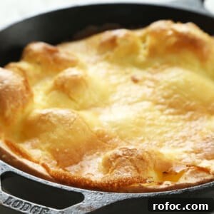 Gluten-Free Dutch Baby Pancake Recipe for Fluffy Morning Brunch 6 gluten free Dutch baby pancake in black Lodge cast iron skillet