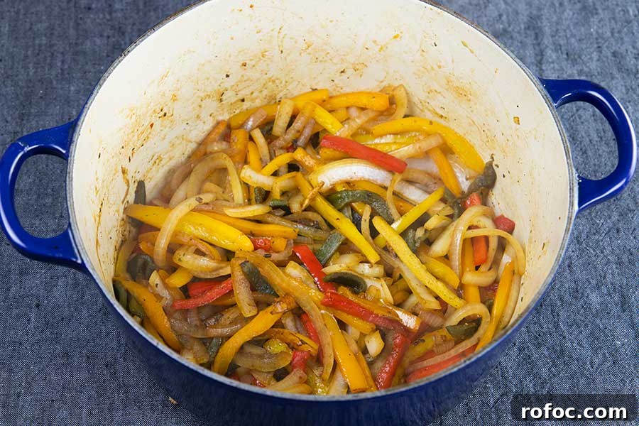 Gluten-Free Chicken Fajita Stew Recipe for Flavorful Weeknights 5 Caramelized peppers in a blue dutch oven.
