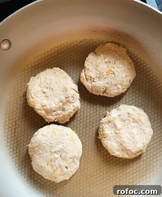 Old Bay Tuna Cakes: Low-Carb, Flavorful Seafood Patties 7 fry tuna cakes on stove