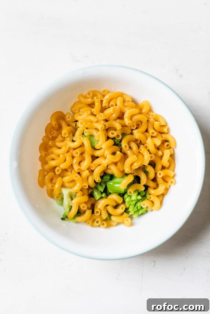 Quick Microwave Mac and Cheese in 5 Minutes 4 bowl with uncooked pasta and broccoli