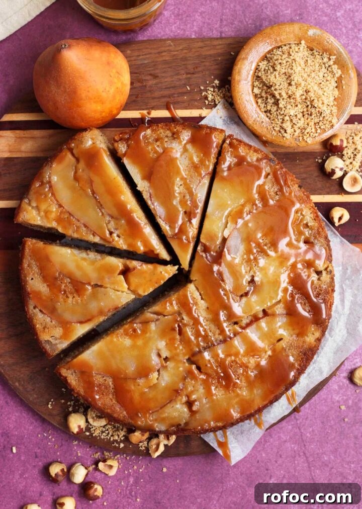 brown butter hazelnut pear upside down cake sliced on cutting board
