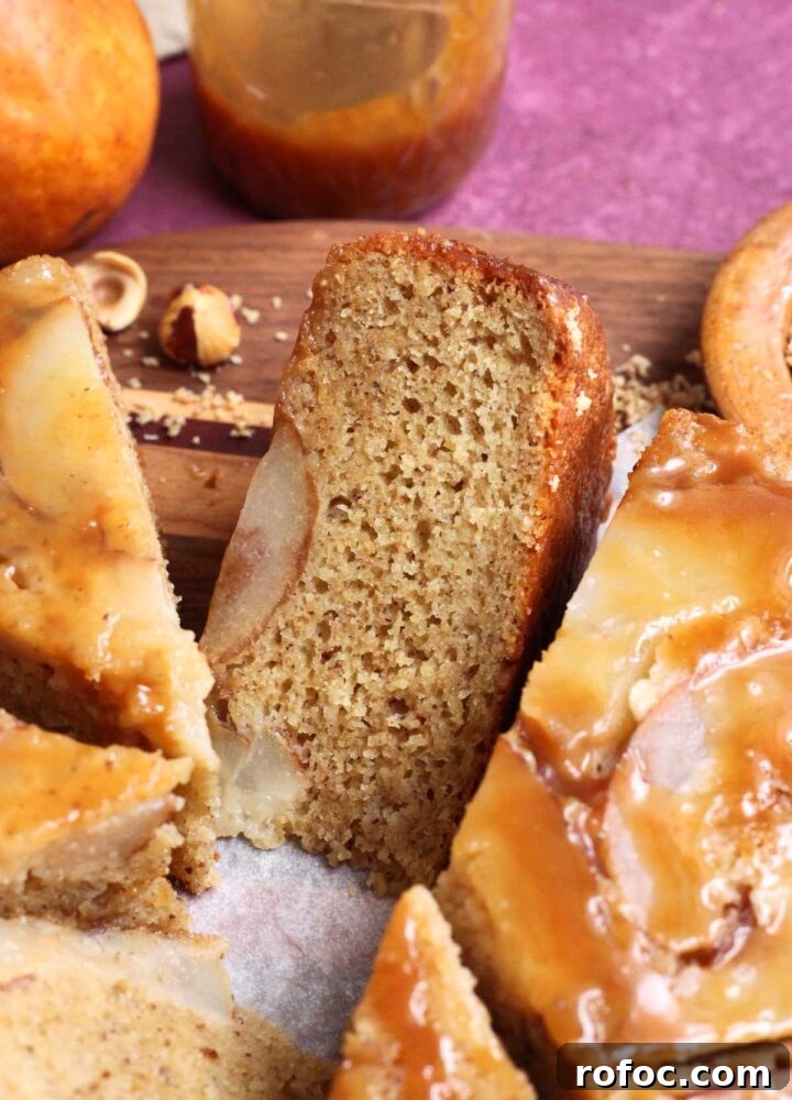 brown butter hazelnut pear upside down cake sliced on cutting board showing crumb texture