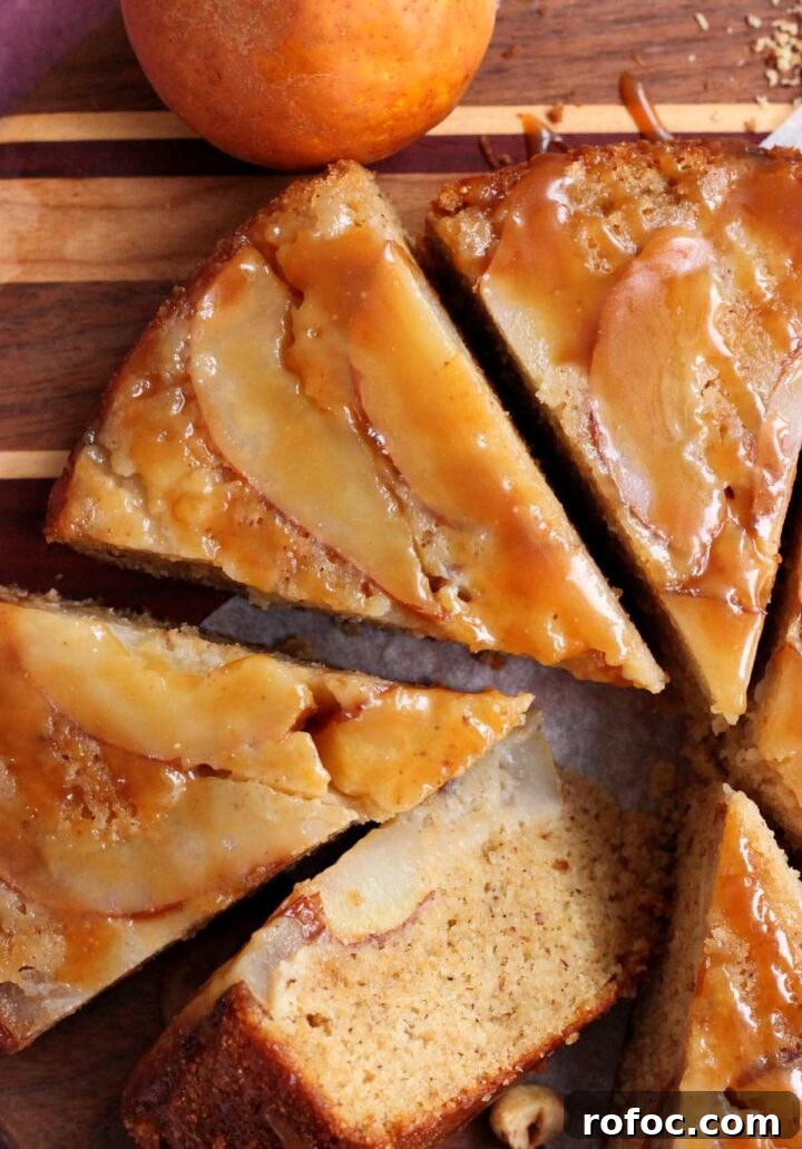 brown butter hazelnut pear upside down cake sliced on cutting board