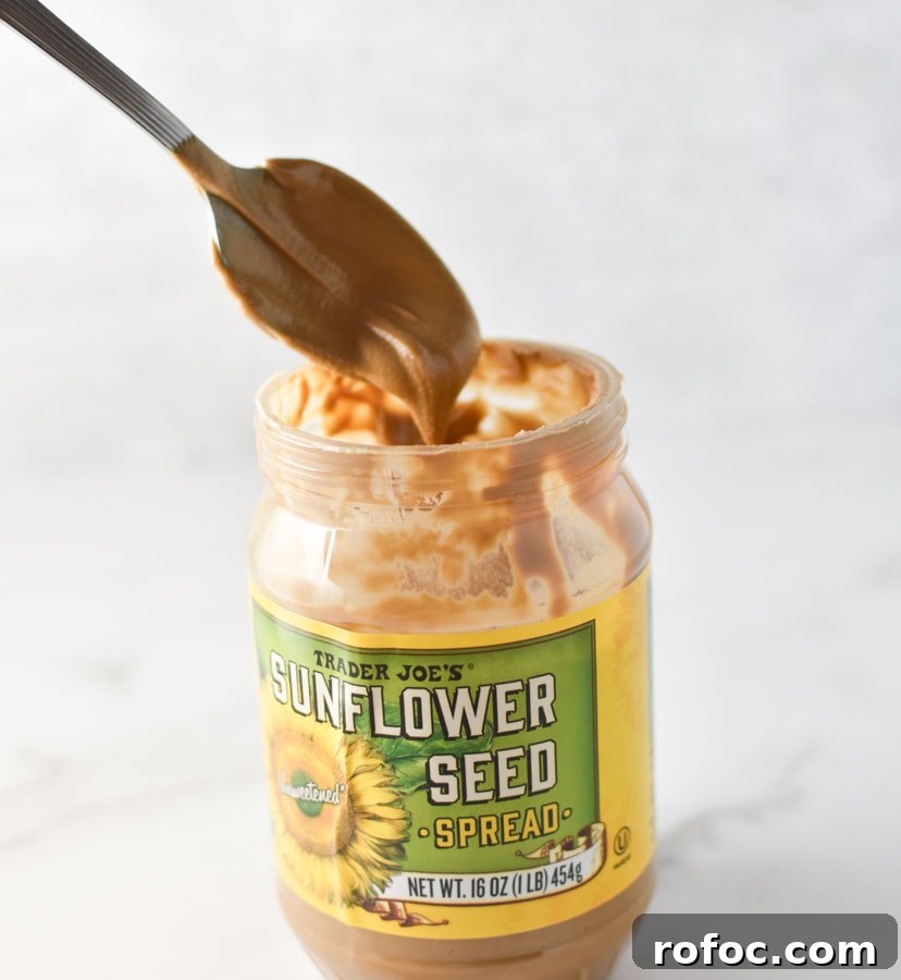 Sunflower Butter Energy Balls — Gluten- and Nut-Free Snacks 3 a spoon dipped into trader joe's sunbutter jar