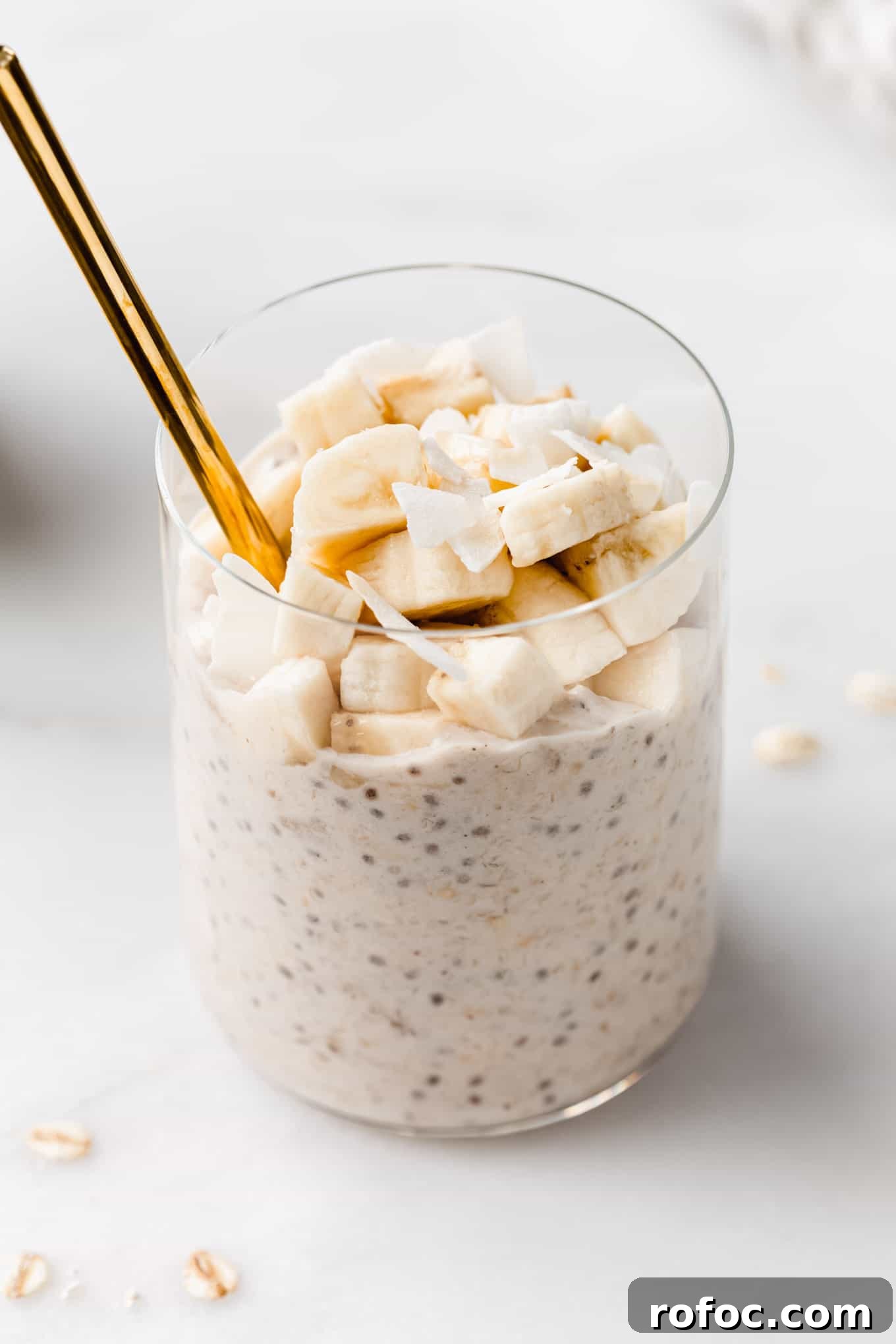 Banana Cream Pie Overnight Oats Recipe for Creamy Make-Ahead Breakfast 2 banana overnight oats in a cup with a gold spoon