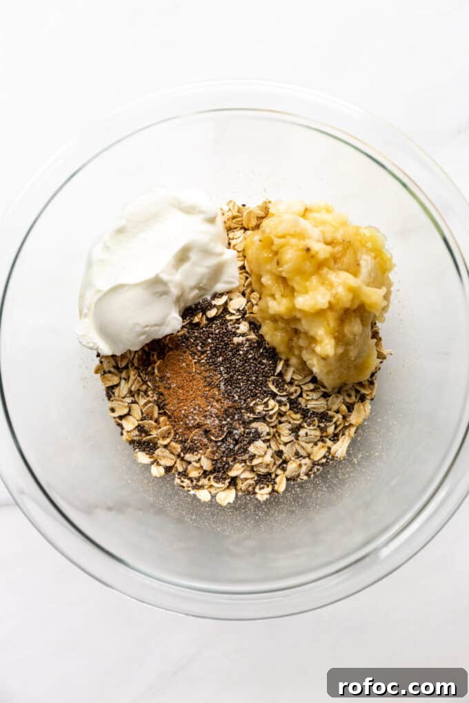 Banana Cream Pie Overnight Oats Recipe for Creamy Make-Ahead Breakfast 5 oats, chia seeds, nutmeg, yogurt and banana in a mixing bowl