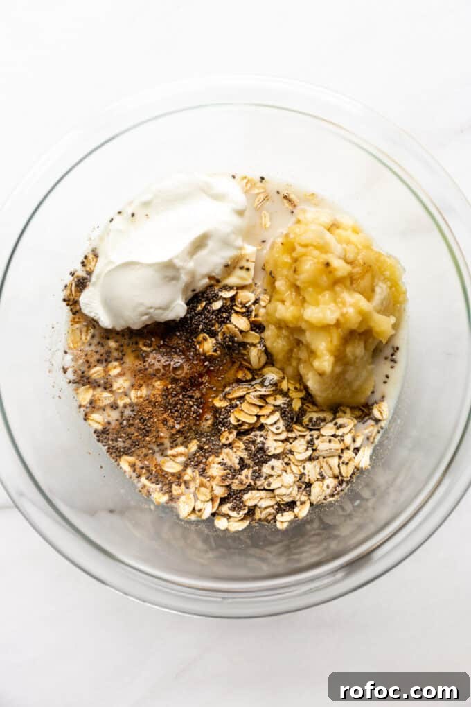 Banana Cream Pie Overnight Oats Recipe for Creamy Make-Ahead Breakfast 6 oats, chia seeds, nutmeg, yogurt, bananas and almond milk in a mixing bowl