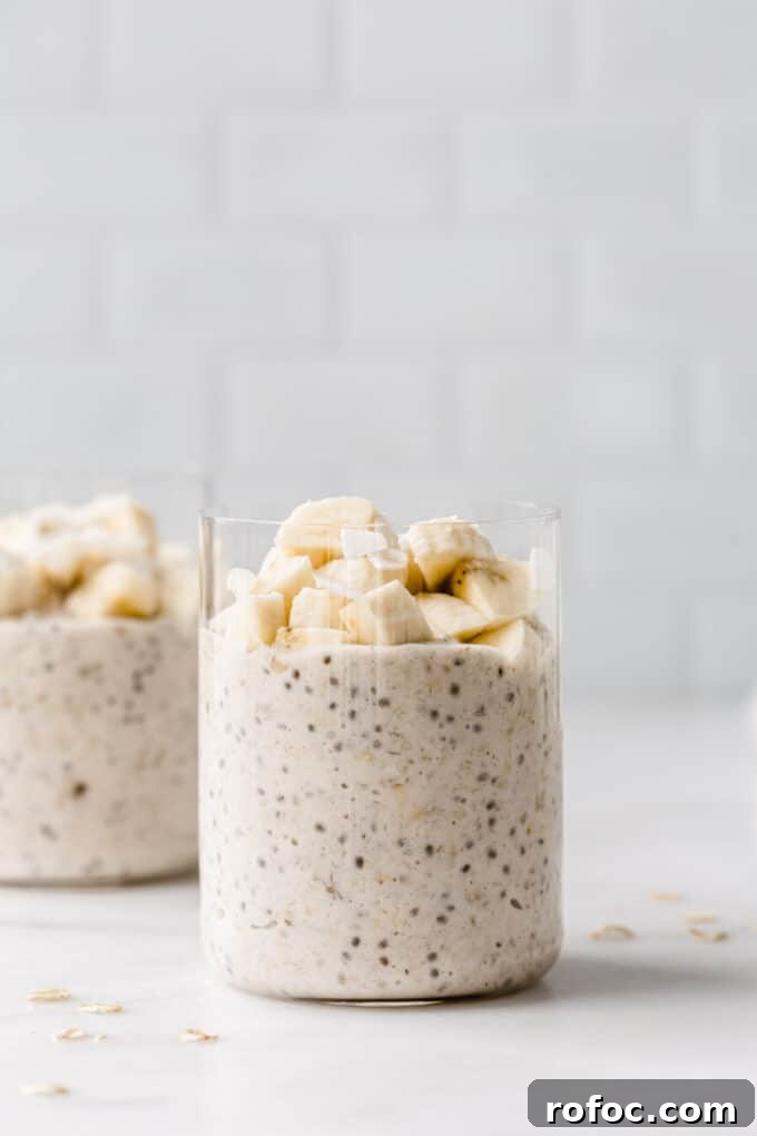 Banana Cream Pie Overnight Oats Recipe for Creamy Make-Ahead Breakfast 9 two cups of banana overnight oats topped with banana.