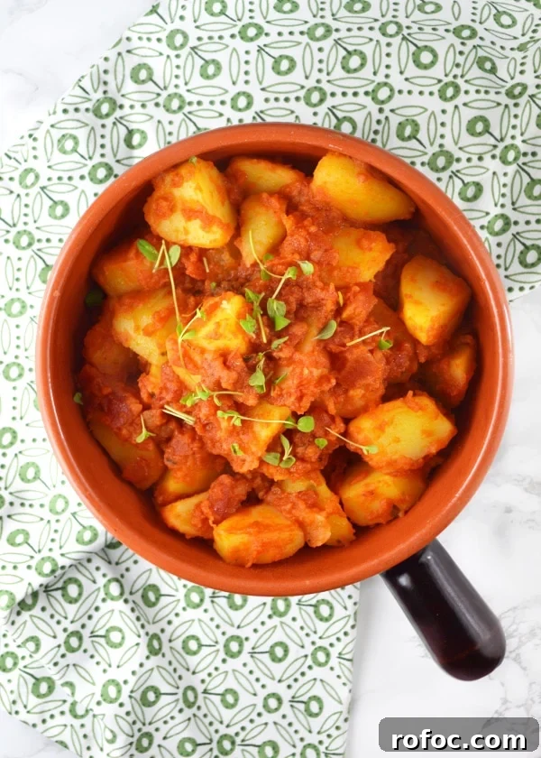 Patate Rifatte (redone potatoes) are a great potato side dish made from leftover boiled potatoes, fried with garlic and herbs and cooked in a delicious tomato sauce. www.insidetherustickitchen.com Patate Rifatte - an Italian potato side dish www.insidetherustickitchen.com