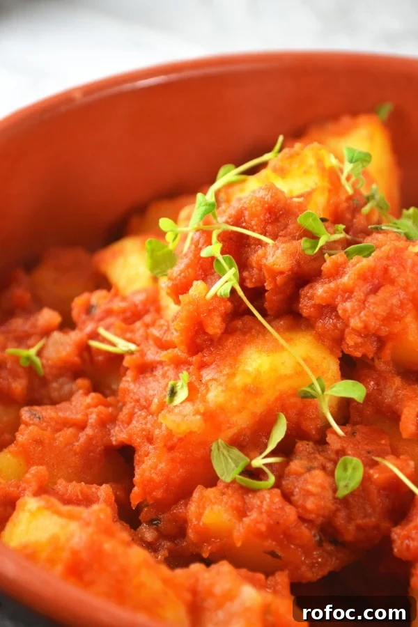 Patate Rifatte (redone potatoes) are a great potato side dish made from leftover boiled potatoes, fried with garlic and herbs and cooked in a delicious tomato sauce. www.insidetherustickitchen.com Patate Rifatte - an Italian potato side dish www.insidetherustickitchen.com